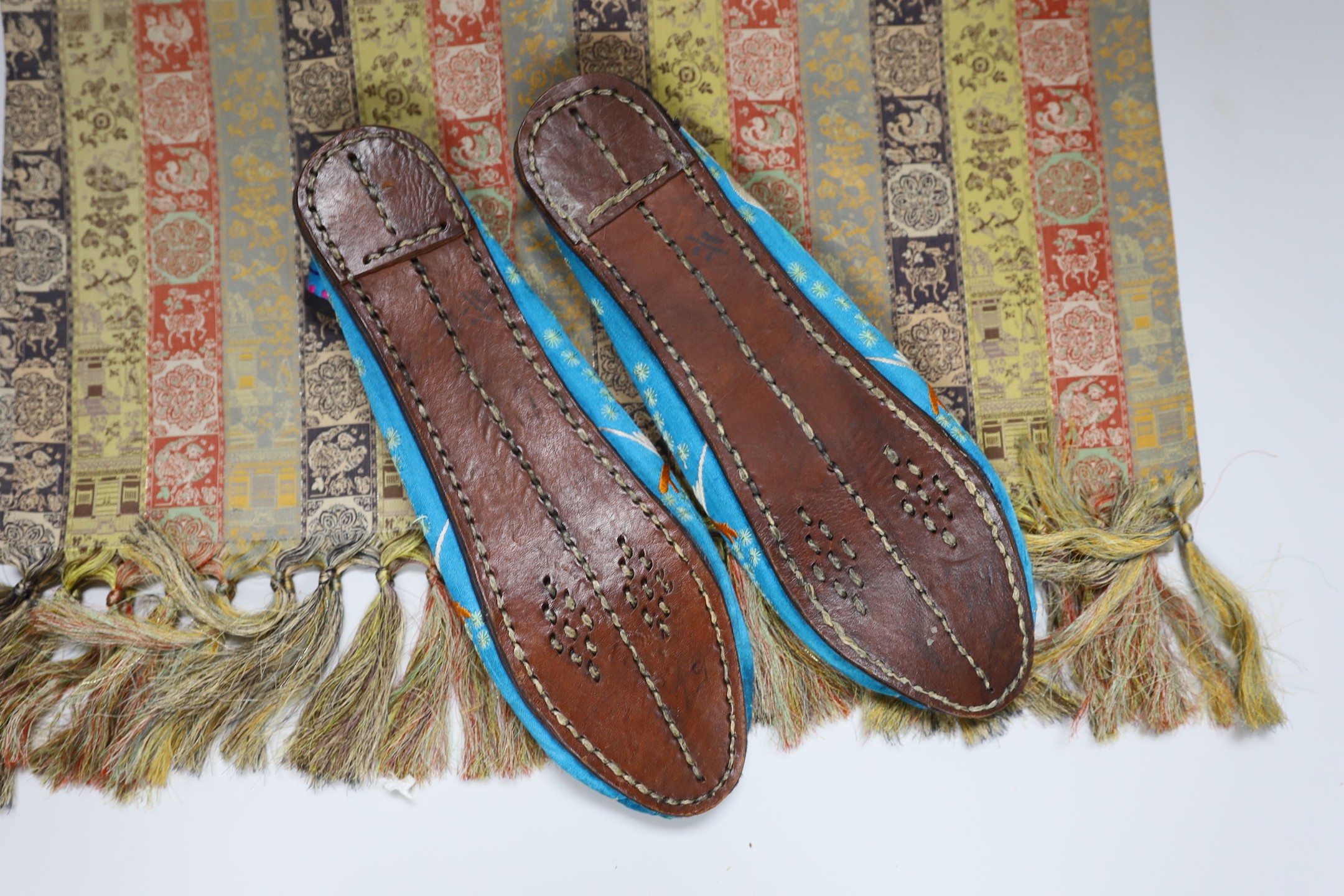 A pair of Chinese silkwork slippers and a Japanese table runner